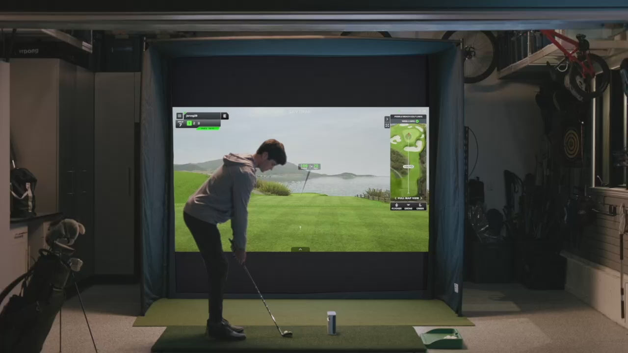 Boy practicing on his golf sim in his garage